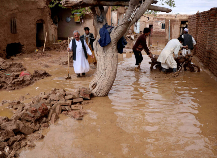 People salvage items from a house destroyed by flood in Enjil district of Herat province In ka badan 100 qof oo lagu waayay daadad ku rogmaday Afgaanistaan